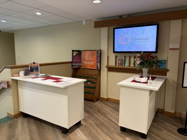 the Emmanuel welcome center with tables and information displayed